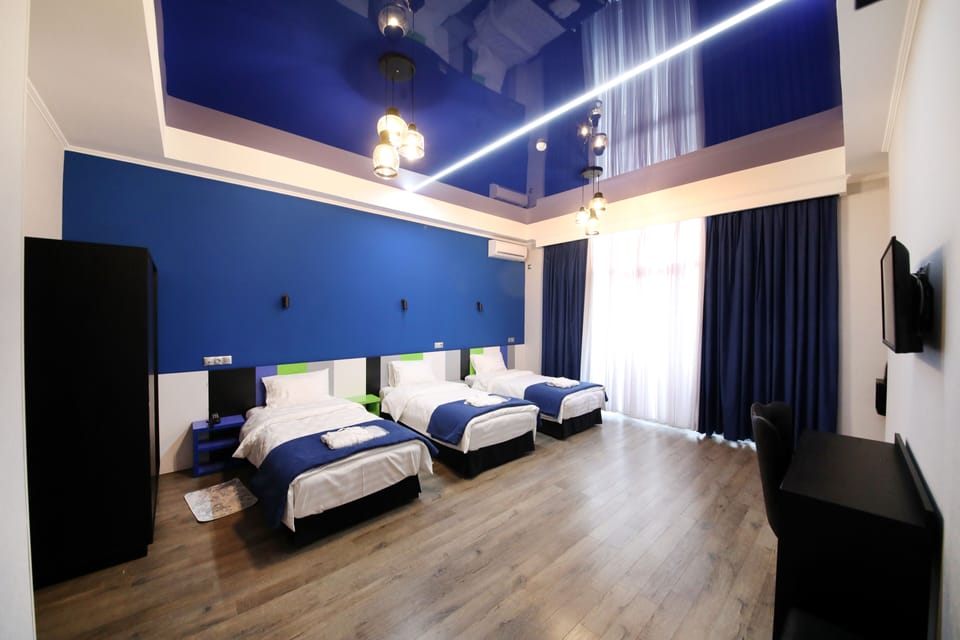 Club Triple Room | Minibar, in-room safe, desk, blackout drapes