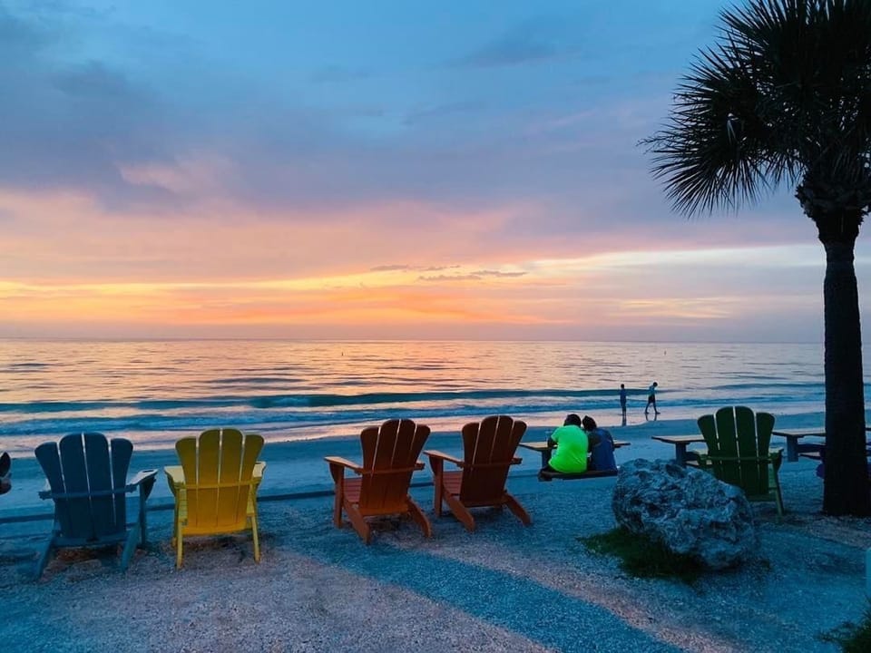 On the beach, white sand, sun loungers, beach umbrellas