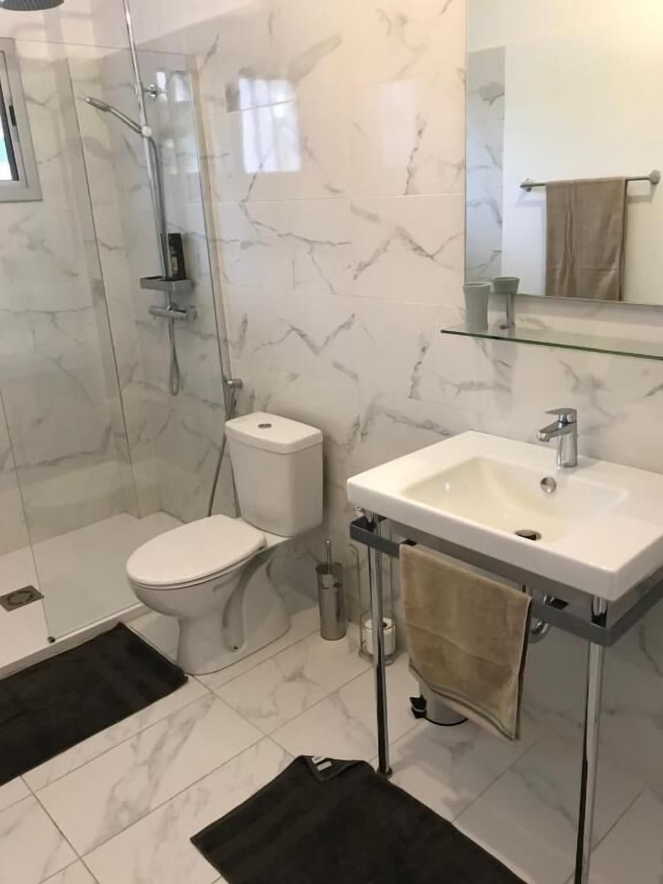 Shower, rainfall showerhead, hair dryer, towels