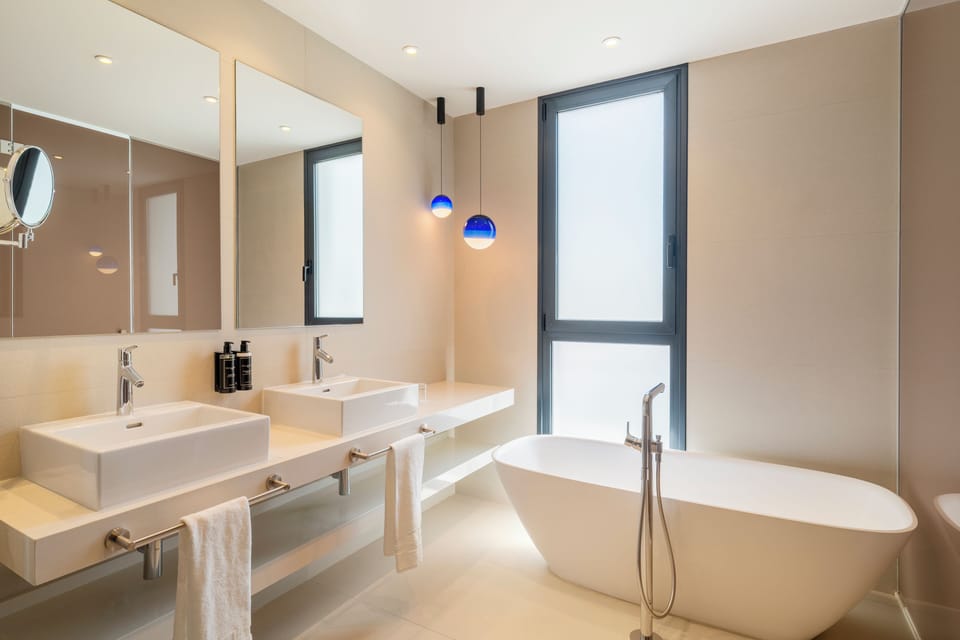 Combined shower/tub, designer toiletries, hair dryer, bathrobes