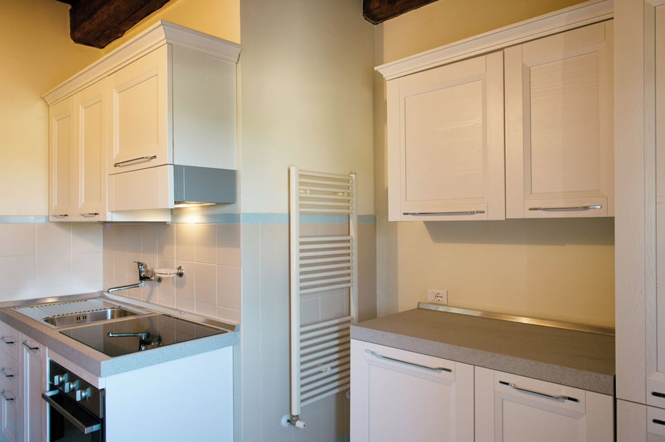 Condo | Private kitchen | Fridge, stovetop, cookware/dishes/utensils, cleaning supplies