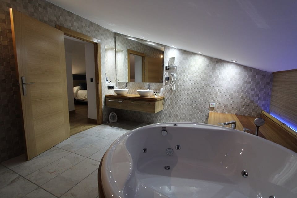 Luxury Studio Suite | Bathroom | Designer toiletries, hair dryer, bathrobes, towels