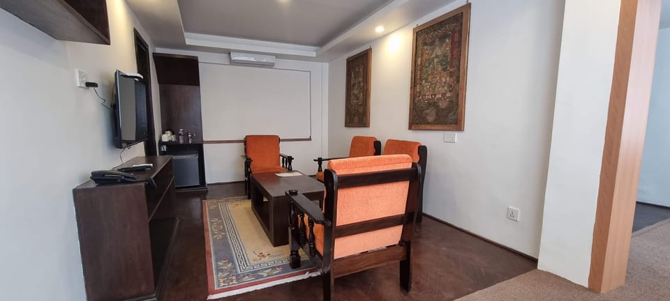 Deluxe Suite | Living area | 40-inch TV with satellite channels