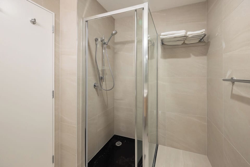 Shower, rainfall showerhead, hair dryer, towels