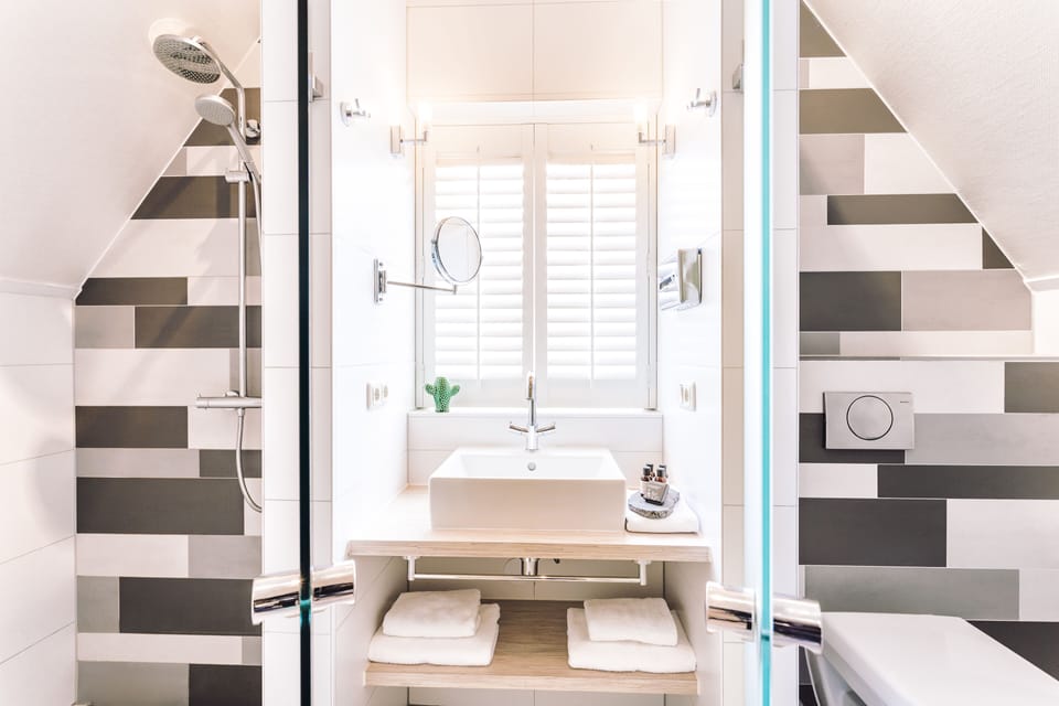 Designer toiletries, hair dryer, bathrobes, towels