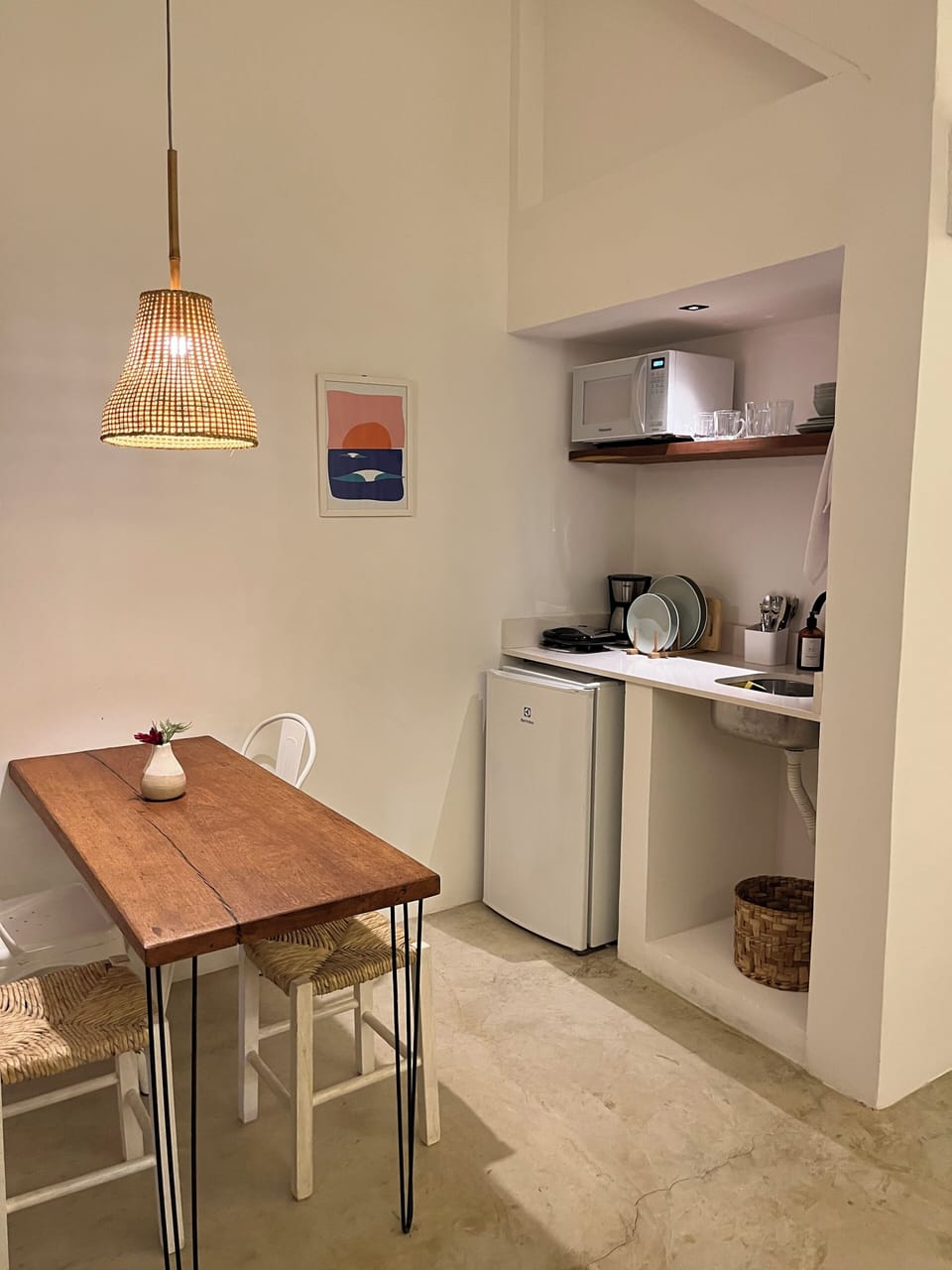 Mini-fridge, microwave, cleaning supplies, dining tables
