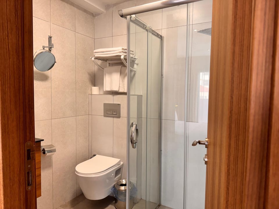 Shower, rainfall showerhead, designer toiletries, hair dryer