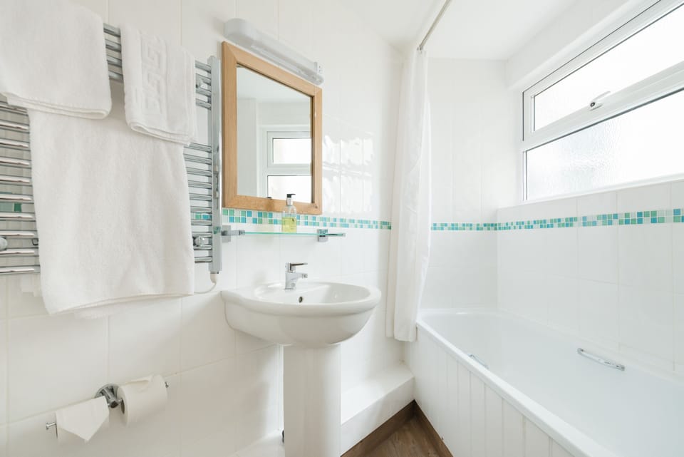 Shower, designer toiletries, hair dryer, towels