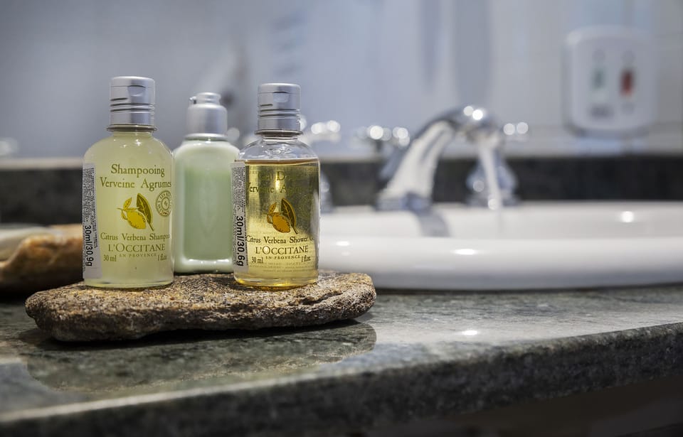 Designer toiletries, hair dryer, towels, soap