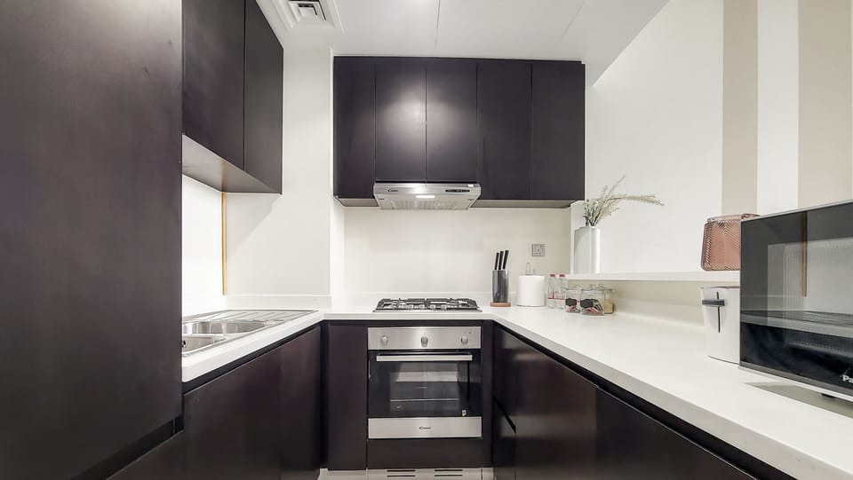 Luxury Apartment | Private kitchen | Fridge, microwave, cleaning supplies, paper towels