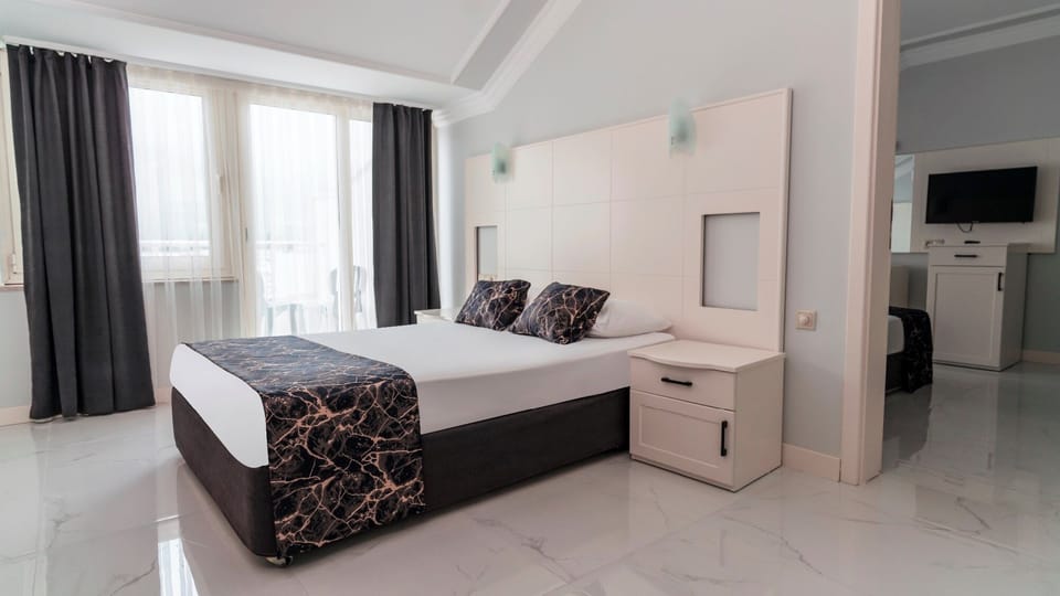 Family Room, 2 Bedrooms | Free minibar, in-room safe, laptop workspace, soundproofing