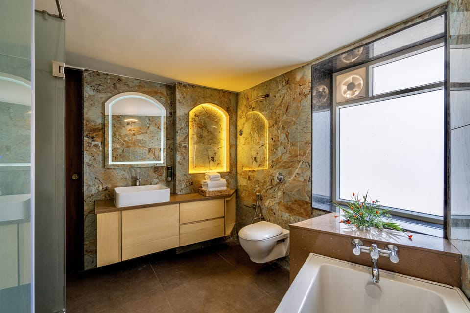 Executive Suite, 1 King Bed | Bathroom | Shower, rainfall showerhead, free toiletries, slippers