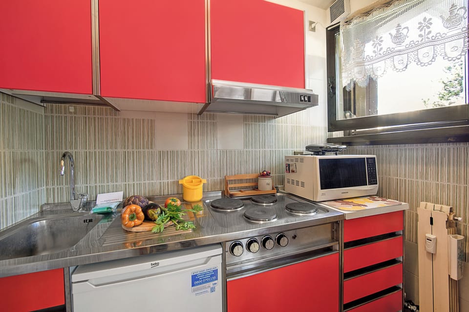 Family Apartment, Multiple Bedrooms (Appartamento Pian dei Larici) | Private kitchen | Fridge, microwave, stovetop, coffee/tea maker