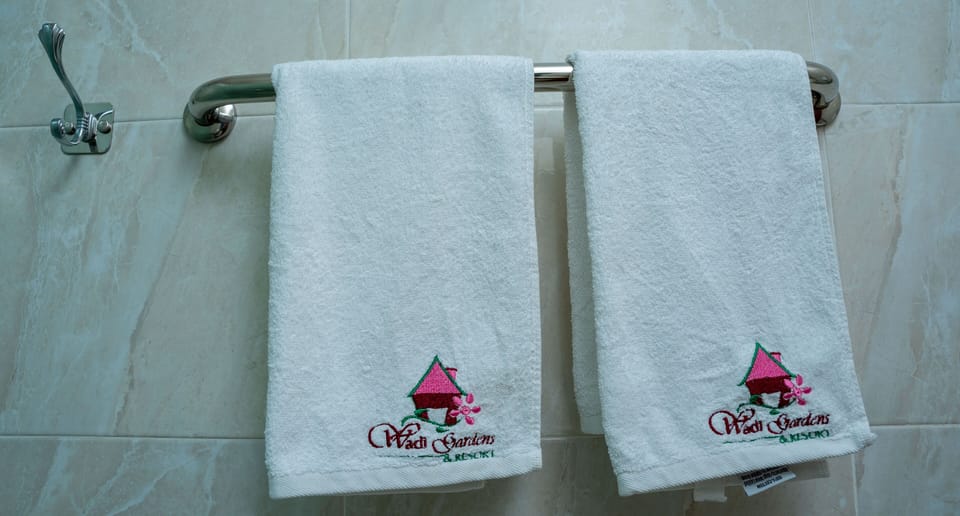 Shower, rainfall showerhead, slippers, towels