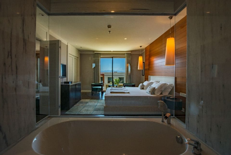 Suite Pool View | Bathroom | Rainfall showerhead, designer toiletries, hair dryer, bathrobes