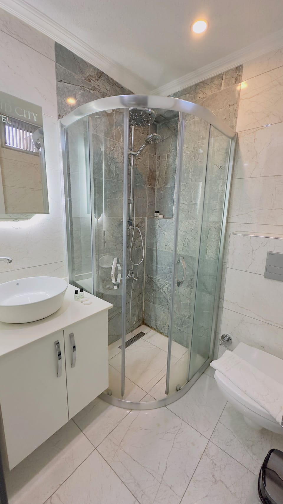 Shower, rainfall showerhead, designer toiletries, hair dryer