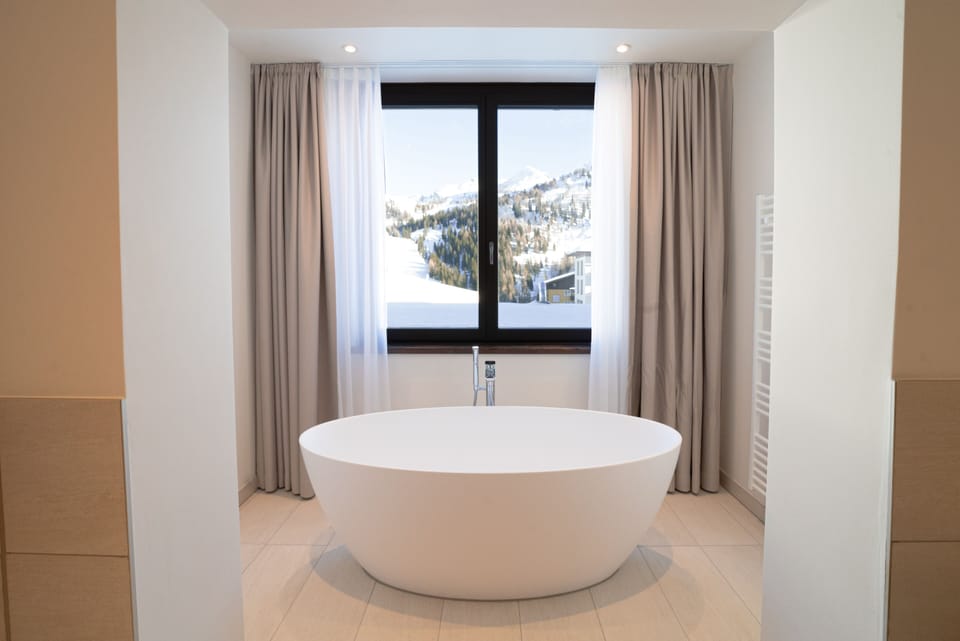 Deluxe Studio | Bathroom | Hair dryer, bathrobes, slippers, towels