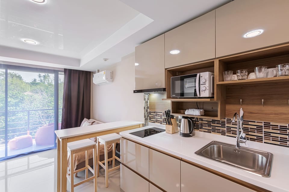 Apartment | Private kitchen | Full-size fridge, microwave, stovetop, highchair