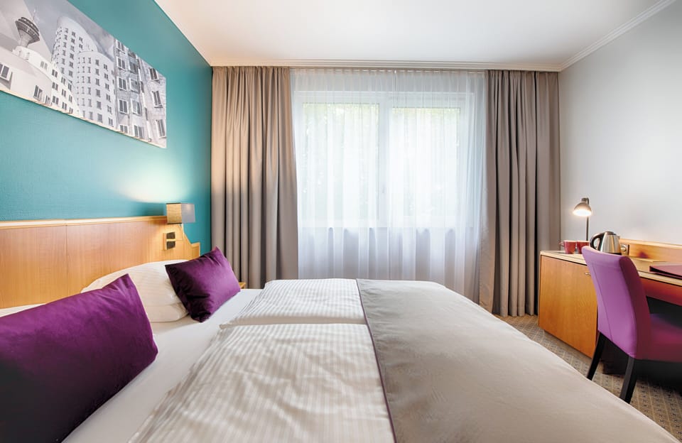 Comfort Triple Room | Minibar, desk, laptop workspace, blackout drapes