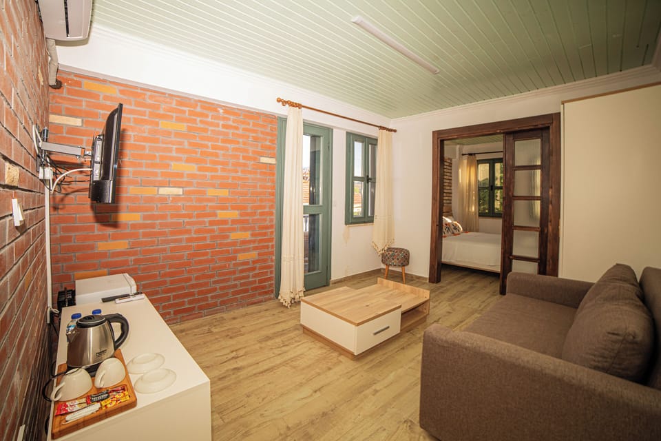 Design Apartment, 1 King Bed with Sofa bed, Courtyard View, Garden Area | Living area | 82-cm Smart TV with satellite channels, TV