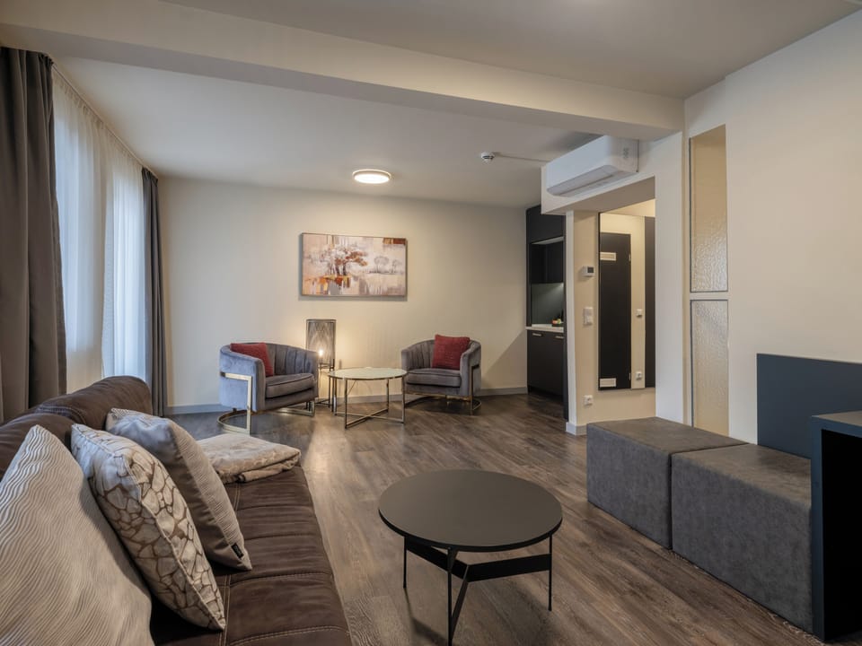 Business Suite, Balcony | Living area | 65-inch flat-screen TV with digital channels, TV, offices