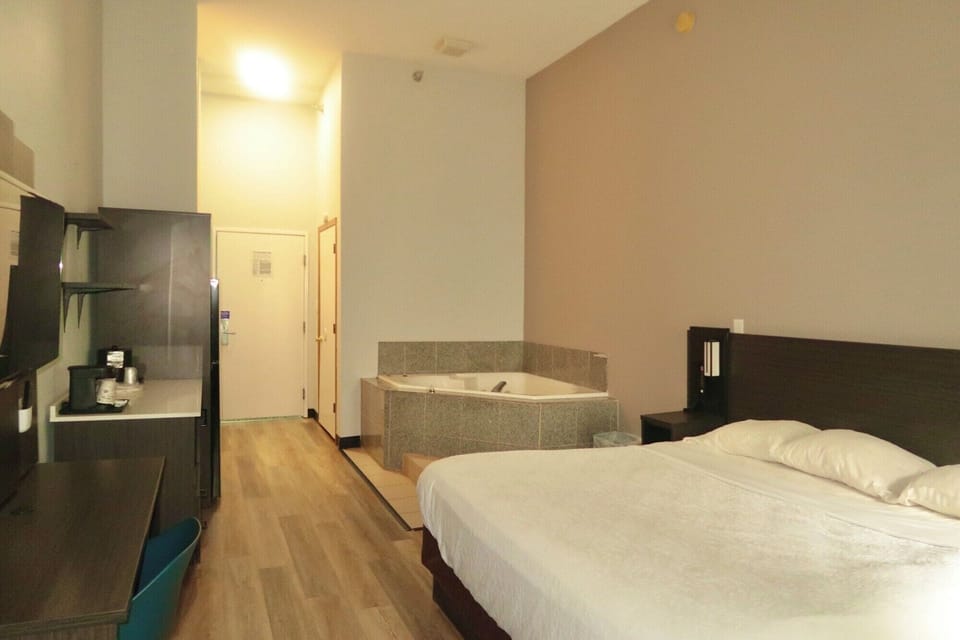 Desk, laptop workspace, blackout drapes, iron/ironing board