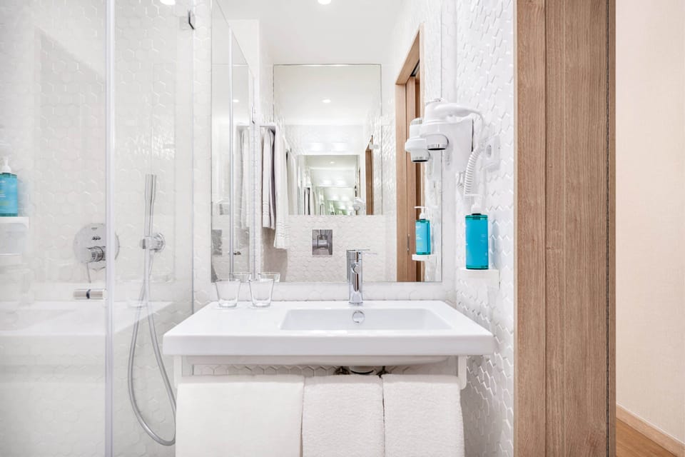 Shower, rainfall showerhead, hair dryer, towels