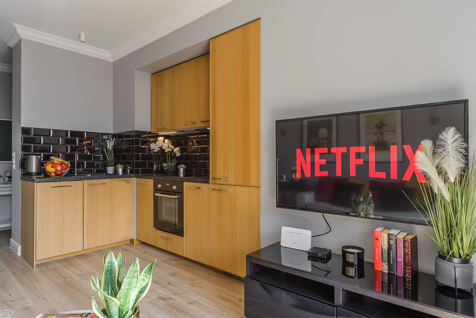 Deluxe Apartment | Living area | 40-inch Smart TV with cable channels