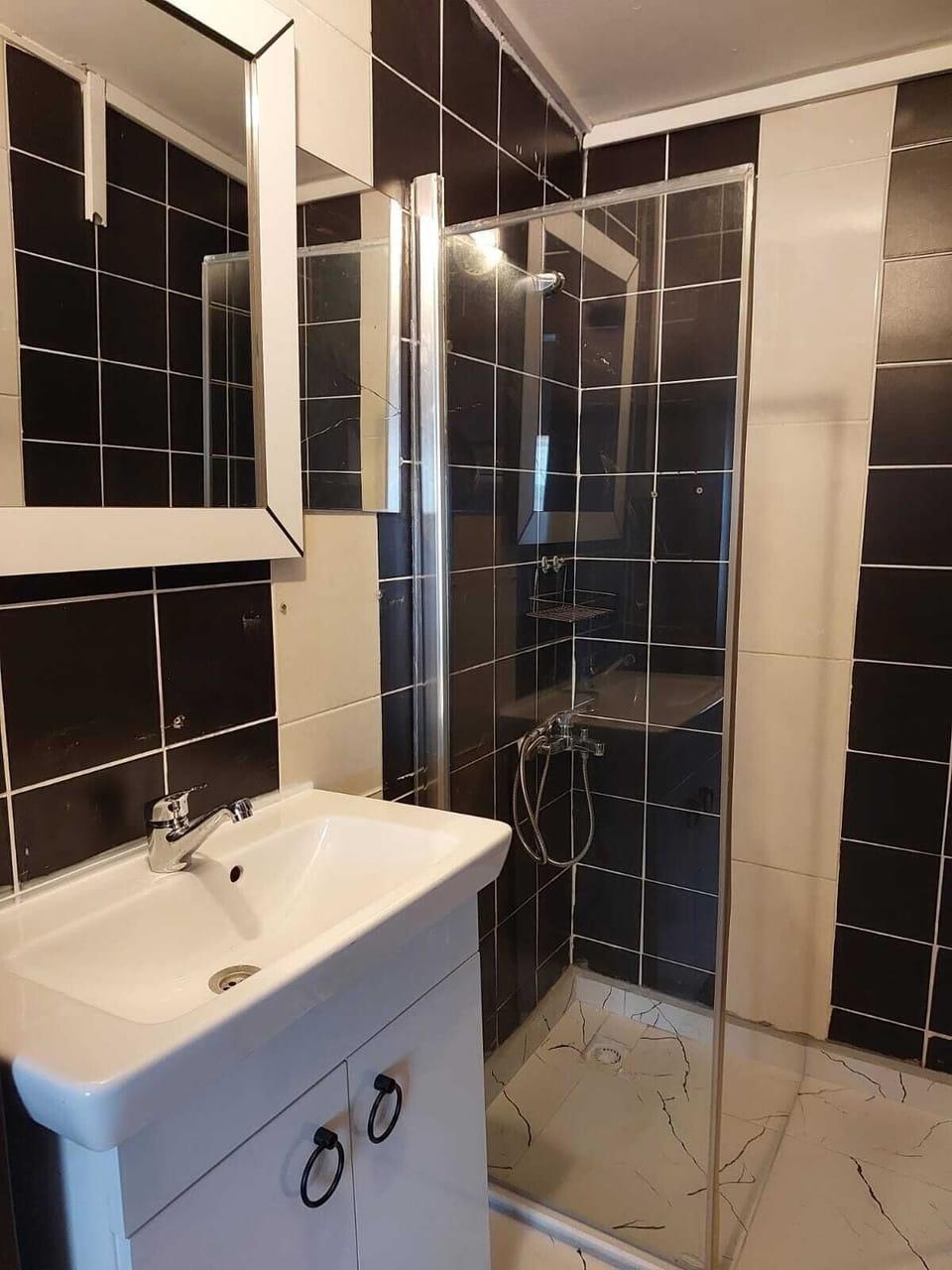 Shower, hair dryer, slippers, towels