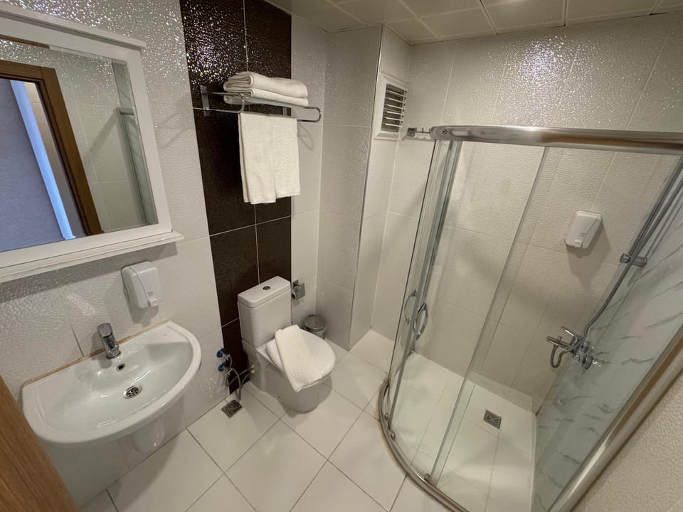 Family Room | Bathroom | Shower, hair dryer, slippers, towels