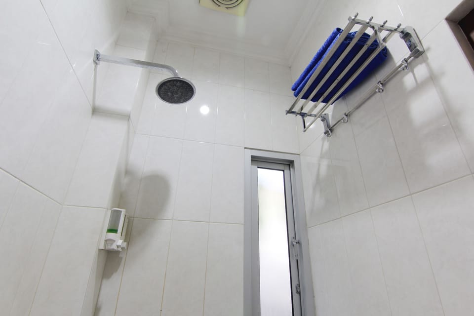 Shower, hair dryer, slippers, towels