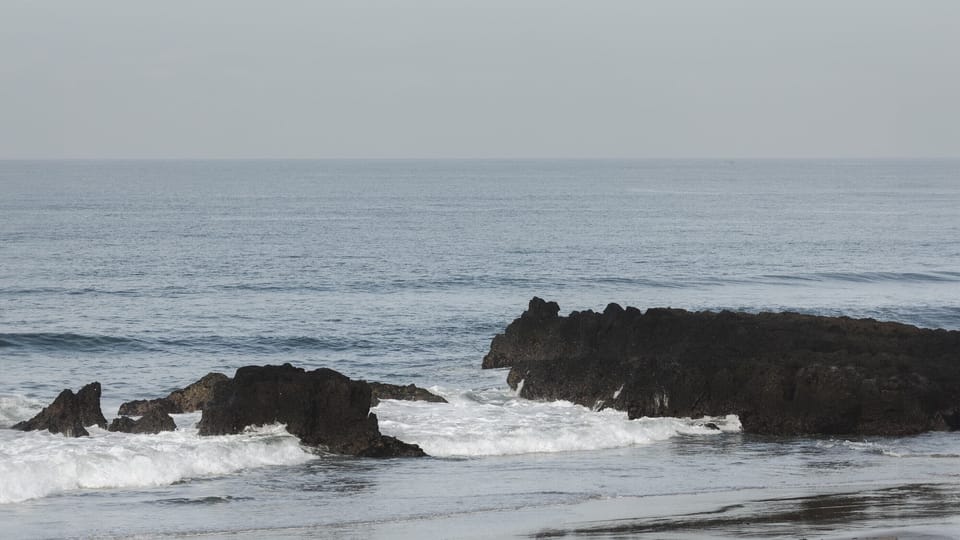 On the beach, black sand