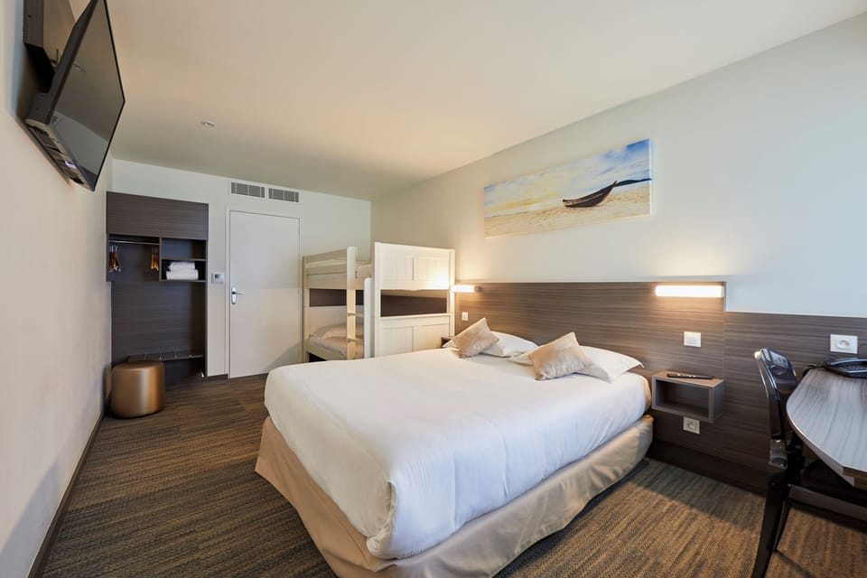 Family Room | Premium bedding, desk, laptop workspace, blackout drapes