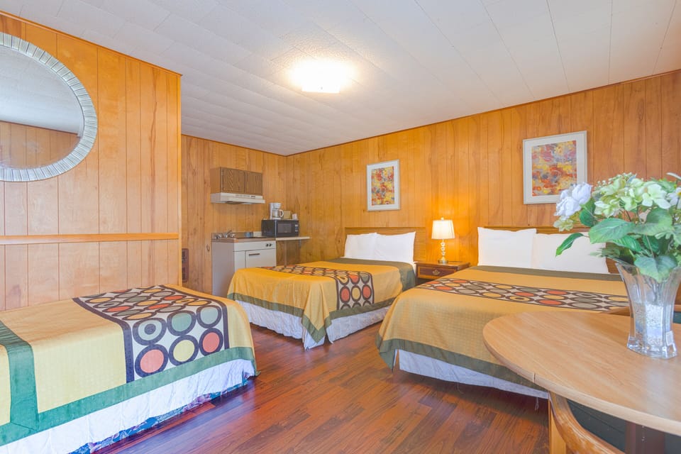 Family room with Kitchenette (2 Queen Bed with Pullout Bed) | Private kitchenette | Mini-fridge, microwave, dining tables
