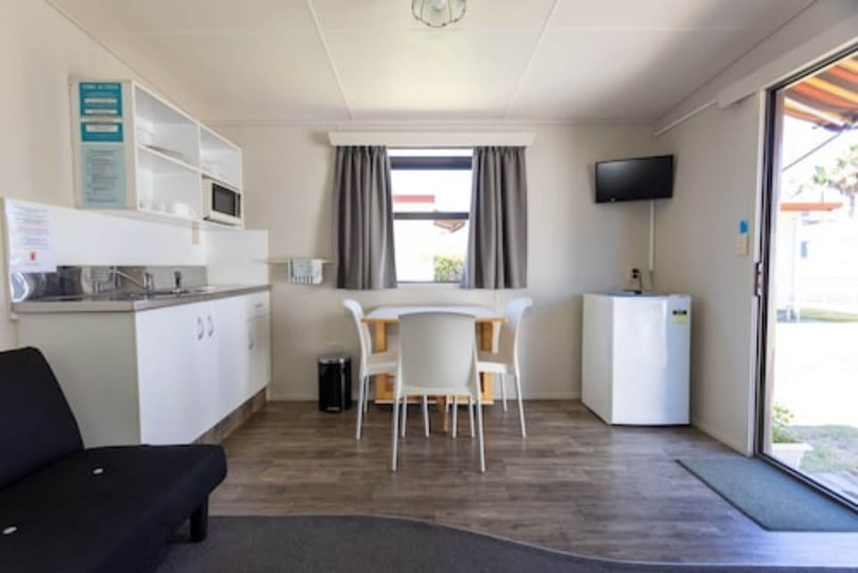 Kitchen Cabin (No Linen Supplied) | Living area | 22-inch flat-screen TV with digital channels, TV, books