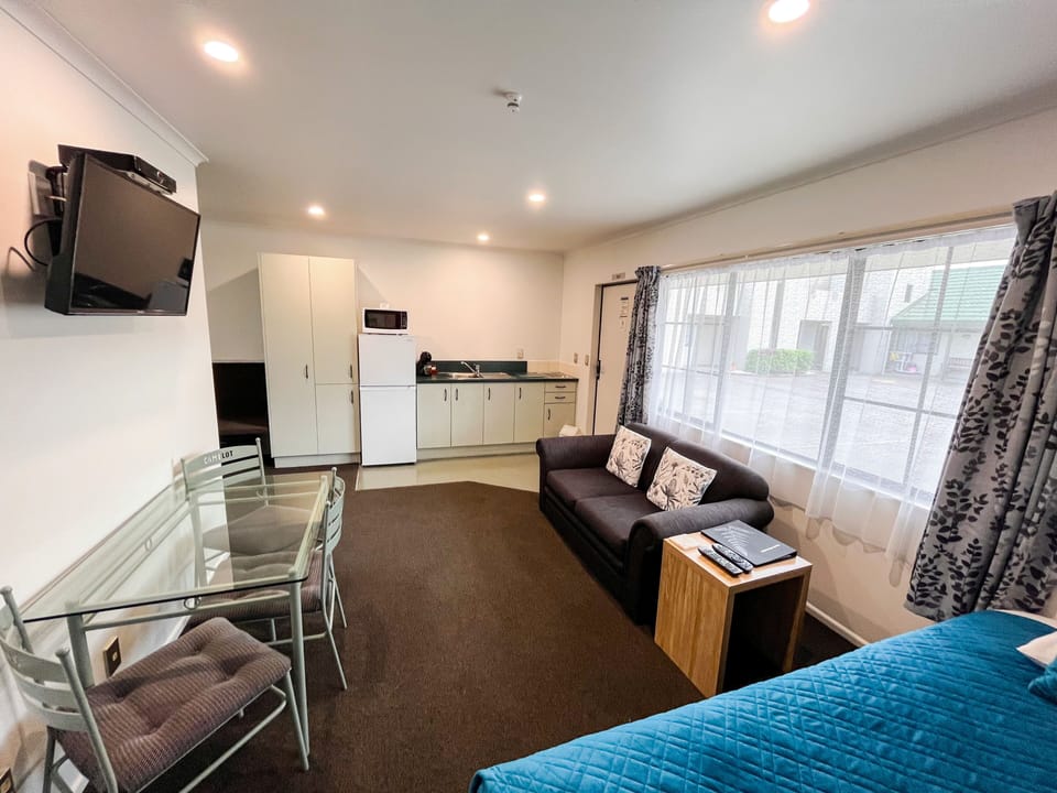 One Bedroom Deluxe | Living area | Flat-screen TV