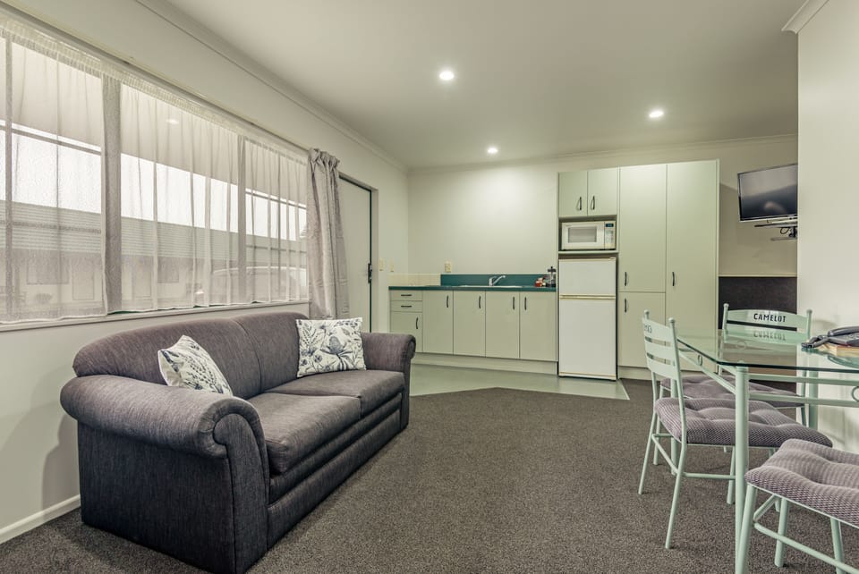 Deluxe One Bedroom Spa Bath | Living area | Flat-screen TV