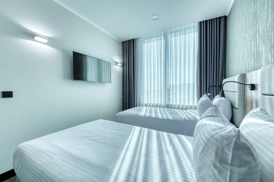 Senior Triple Room, 2 Bedrooms | Desk, laptop workspace, bed sheets