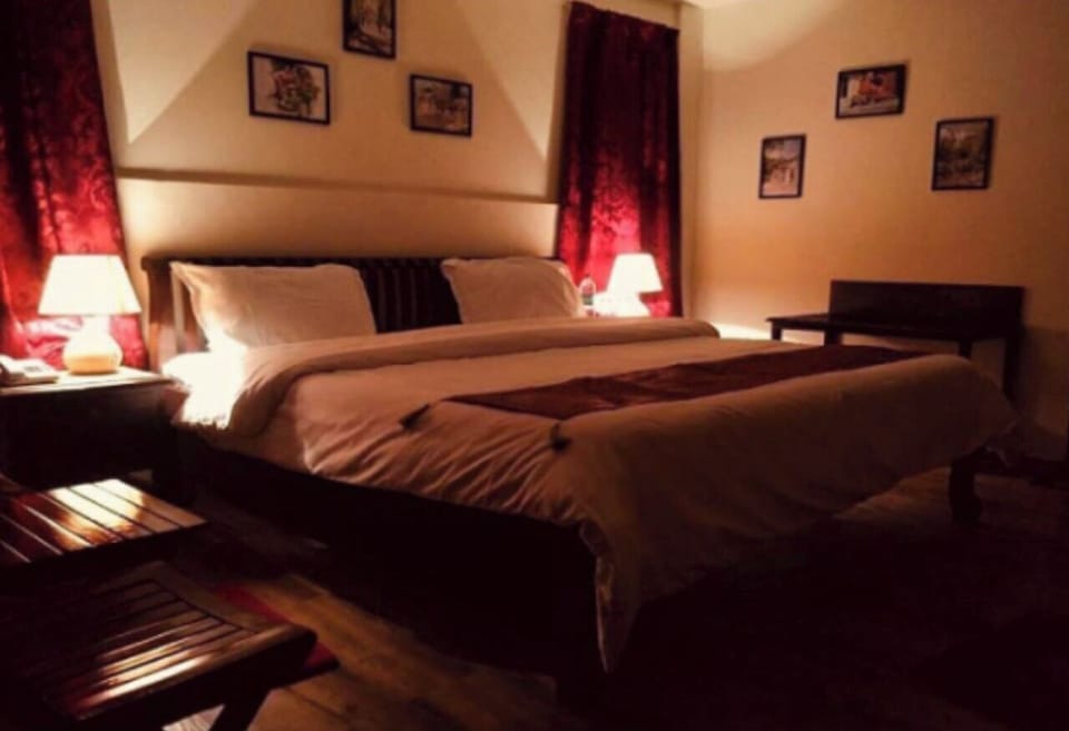 Desk, iron/ironing board, bed sheets