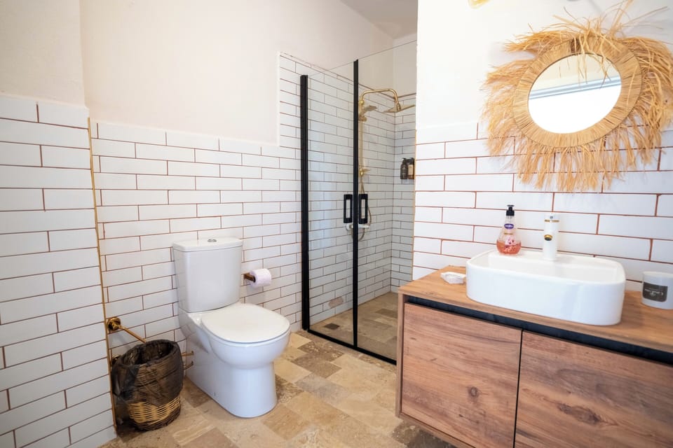 Deluxe Triple Room, Partial Sea View | Bathroom | Shower, rainfall showerhead, hair dryer, slippers