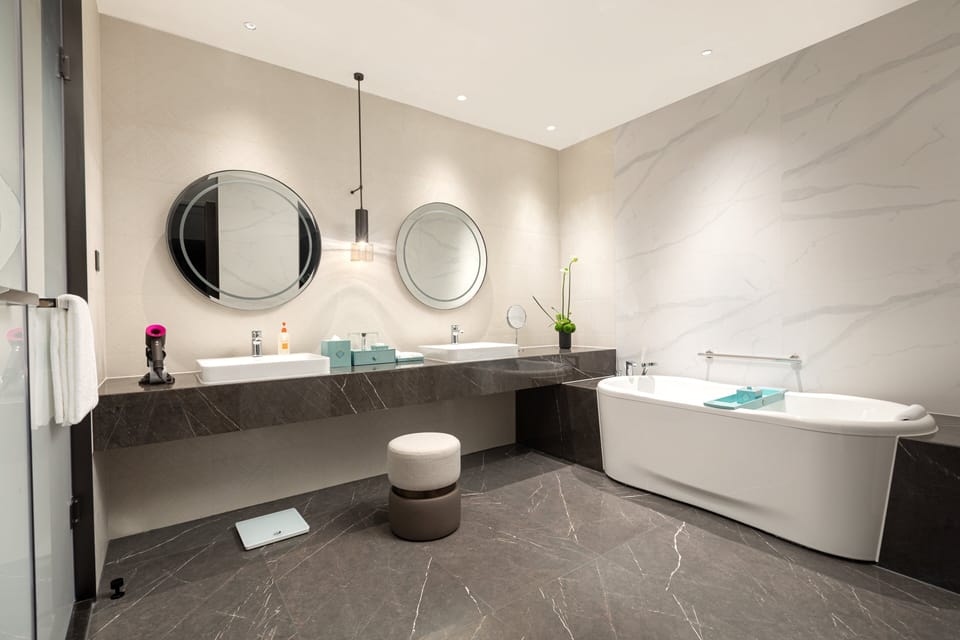 Suite, 1 King Bed (Ambassador) | Bathroom | Rainfall showerhead, designer toiletries, hair dryer, bathrobes