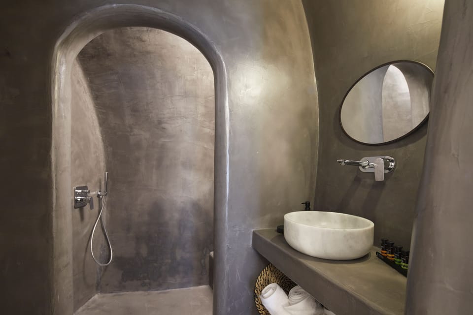 Lithos Cave Room | Bathroom | Shower, rainfall showerhead, hair dryer, bathrobes