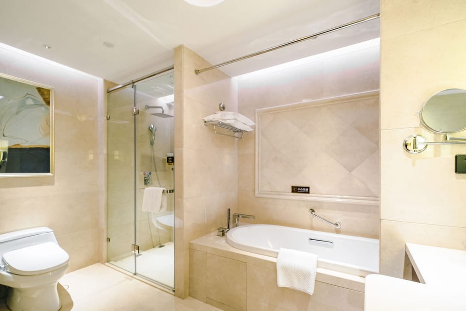 Standard Suite | Bathroom | Rainfall showerhead, hair dryer, bathrobes, slippers
