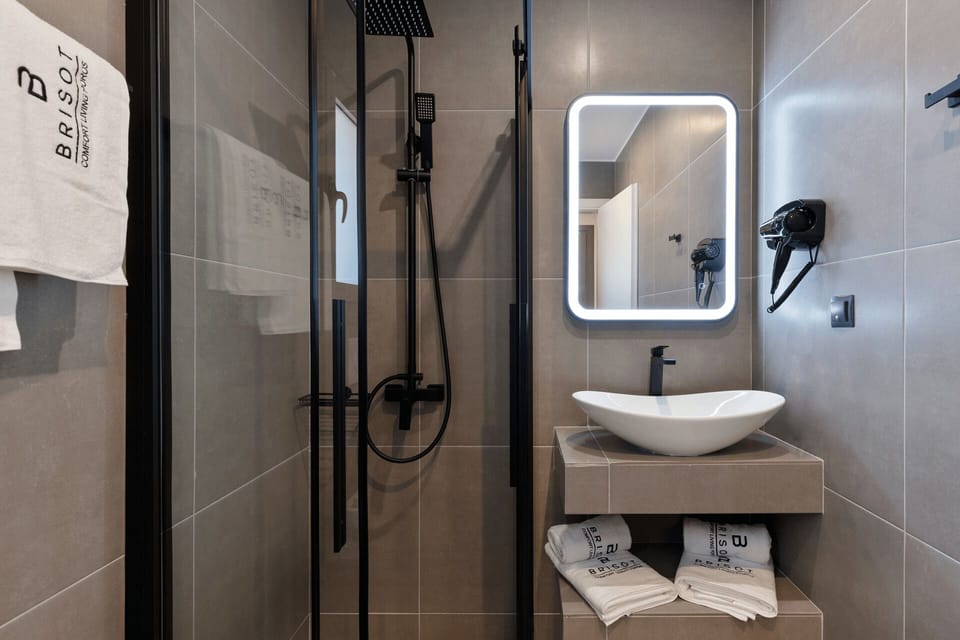 Shower, rainfall showerhead, hair dryer, towels