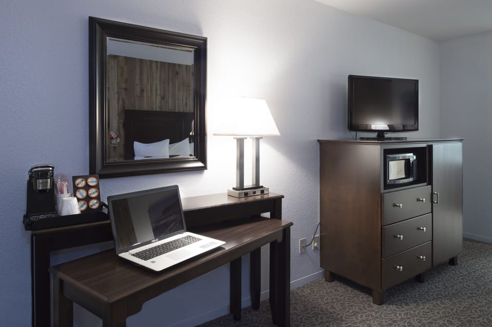 Desk, laptop workspace, iron/ironing board, cribs/infant beds