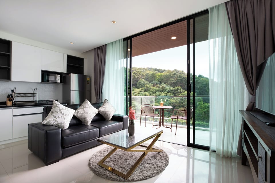 Deluxe Condo | Living area | Flat-screen TV