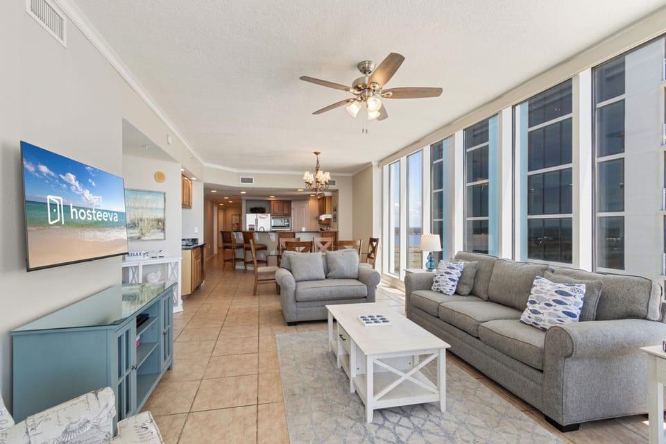 Signature Apartment, 4 Bedrooms, Balcony, Beach View | Living room | 50-inch Smart TV with cable channels, video-game console, books