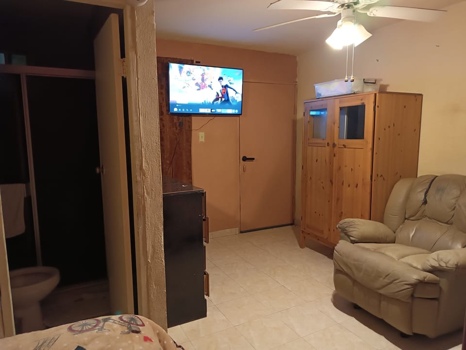 Family Quadruple Room | Living area | 32-inch TV with satellite channels