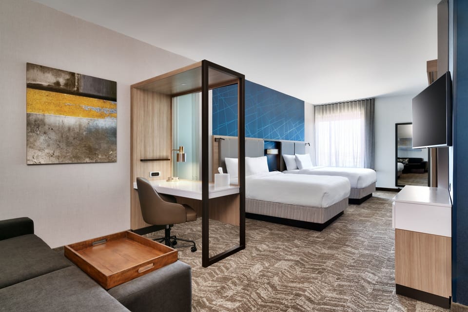 Hypo-allergenic bedding, desk, laptop workspace, blackout drapes