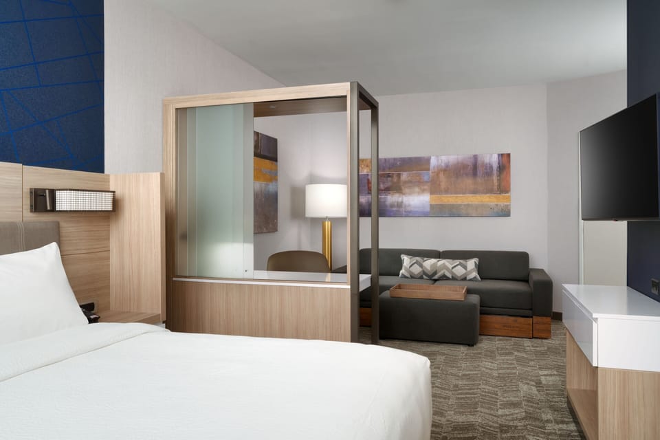 Hypo-allergenic bedding, desk, laptop workspace, blackout drapes